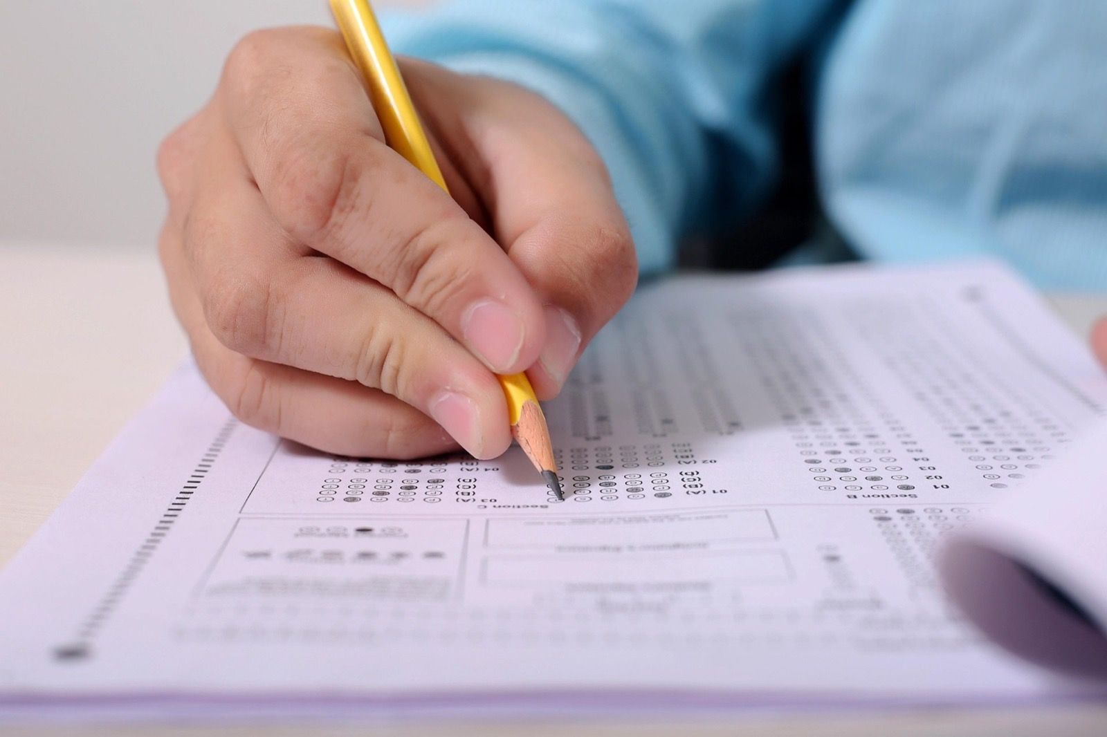 A child completing a written screening at a desk in a pediatric office